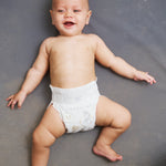 Newborn baby lying down in Lovekins TriplePro Bio nappy